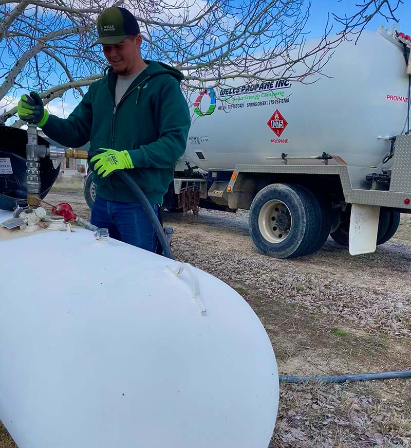 propane delivery driver fueling a tank